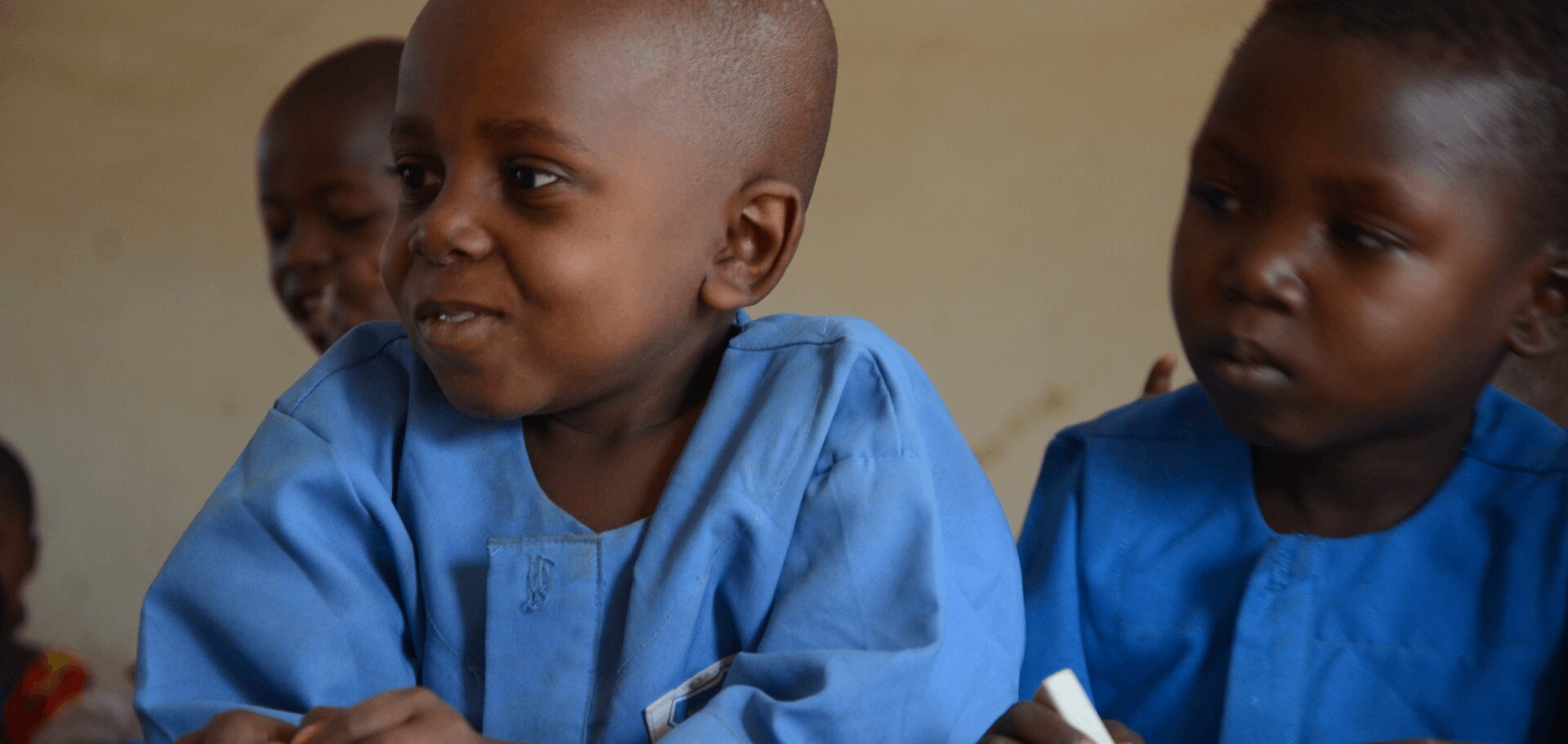 banner_nigeria_two-boys-in-blue-uniforms-sit-at-a-school-desk