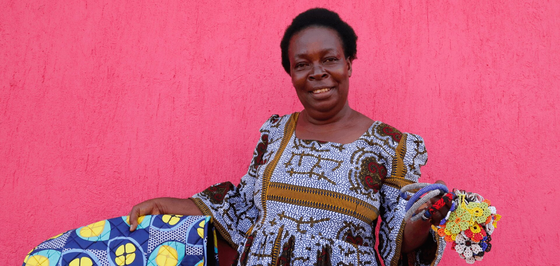 cta_uganda_congolese-woman-holds-brightly-coloured-handicrafts