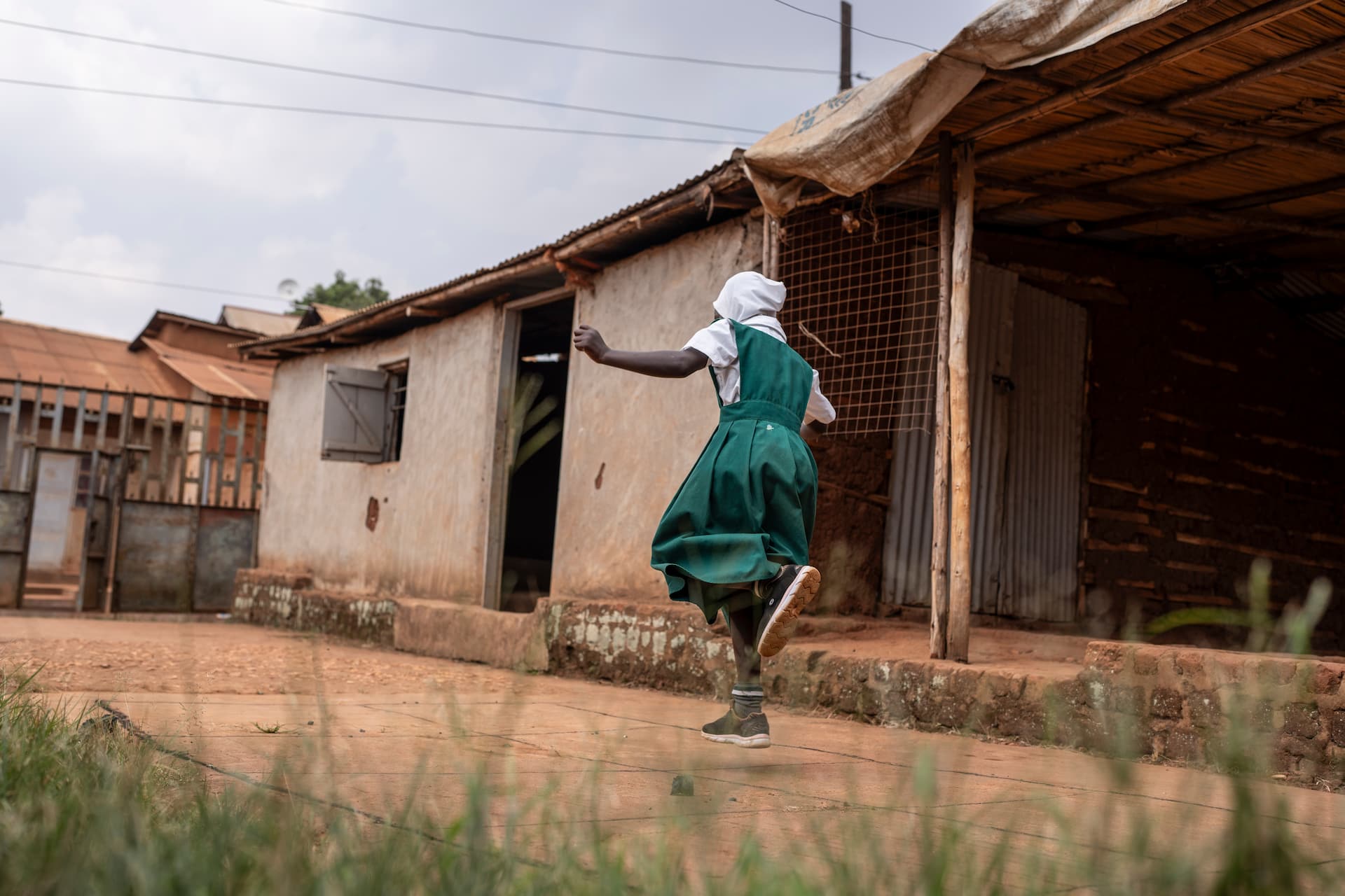 Uganda_Sudanese-Refugee-Leila-Plays-In-The-Yard-Outside-Her-Home-In-Kampala