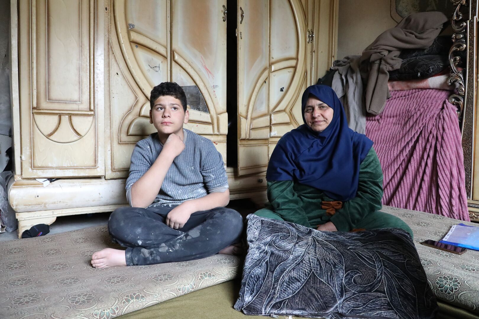 Syria_Ibtihal-and-her-youngest-son-Omar-in-their-damaged-home